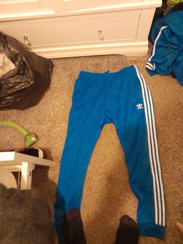 Preview of the first image of A blue and white adidas original tracksuit large mens.