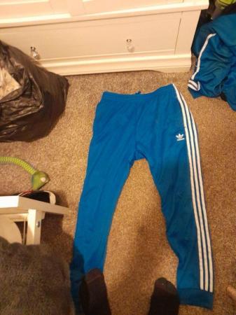 Image 1 of A blue and white adidas original tracksuit large mens