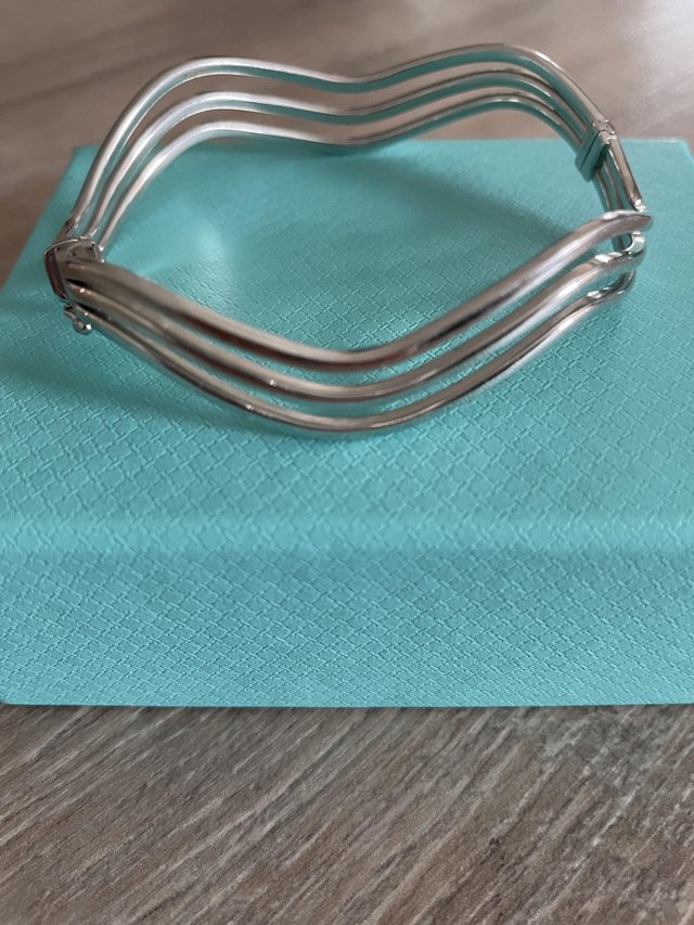 Preview of the first image of 9ct white gold wavy bangle.