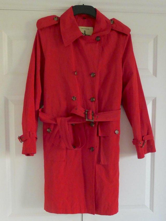Preview of the first image of Paula Costello red trench coat with pockets.
