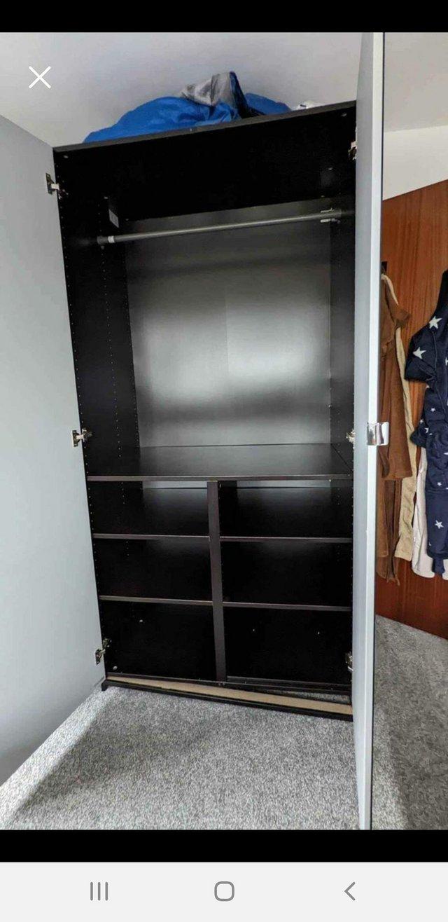 Preview of the first image of Ikea pax wardrobe with mirror doors blackcolour.