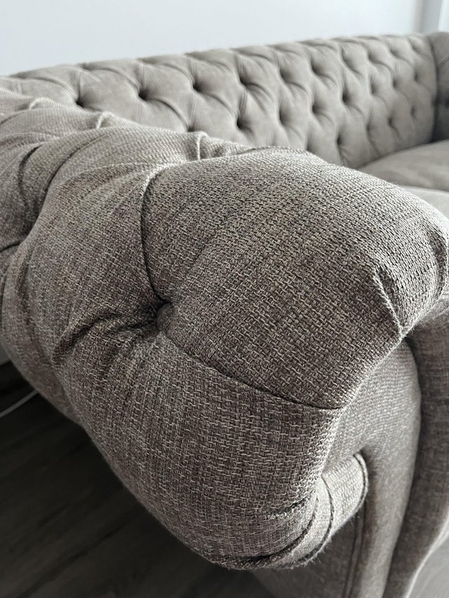 Preview of the first image of Large two seater grey chesterfield sofa.