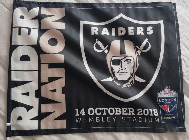 Preview of the first image of Raider Nation hand held flag made of cloth.