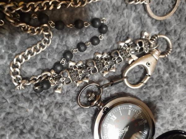 Image 1 of black pocket watch with goth type chain.