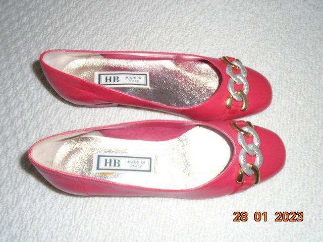 Preview of the first image of HB brand new and unworn red leather low heeled pumps.