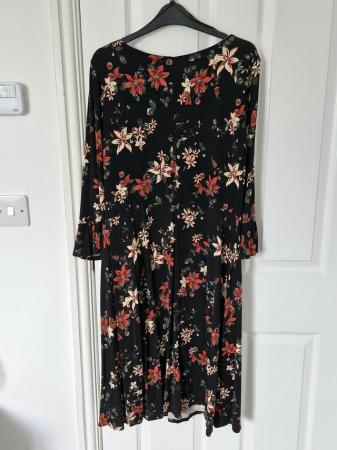 Image 3 of Black Floral Dress with Bell Sleeve.