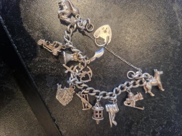 Image 3 of Silver marked charm bracelet with 11 charms and heart lock c