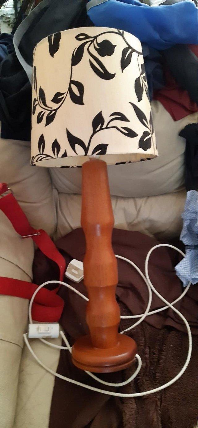 Preview of the first image of Hand carved teak antique table / side lamp.