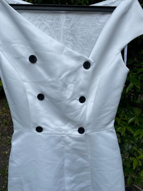 Preview of the first image of Unique hand made satin wedding dress with black buttons.