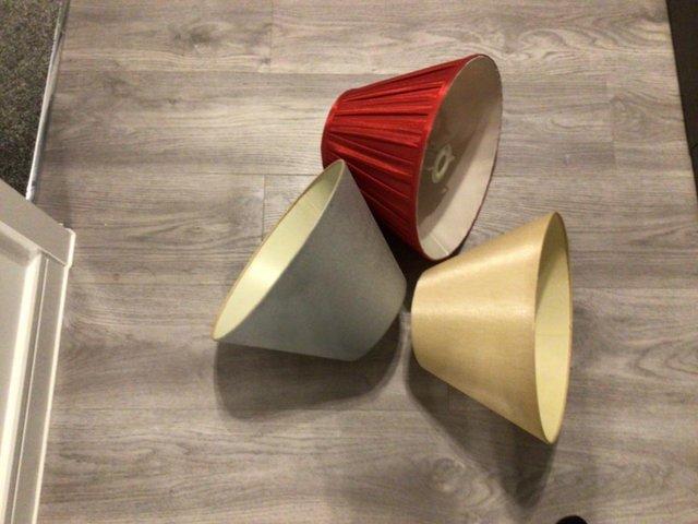 Preview of the first image of Lamp shades x 2, gold and red.