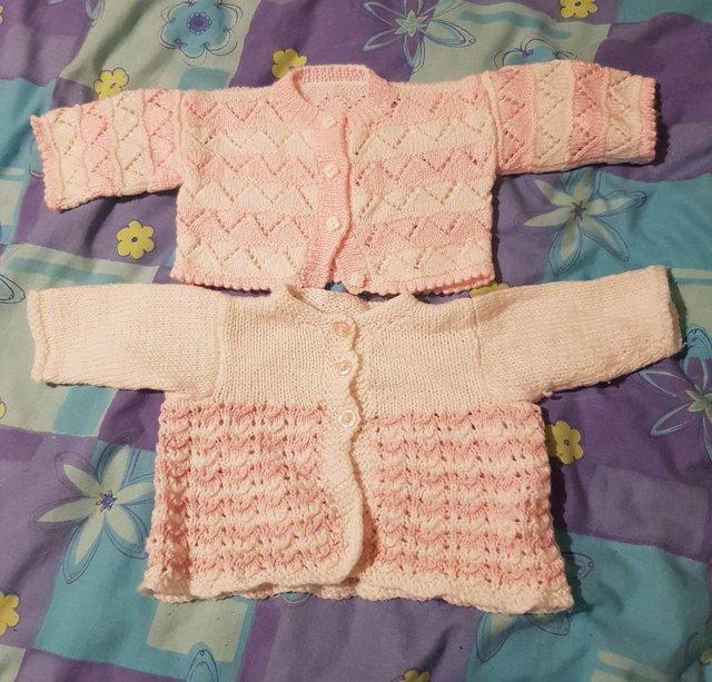 Preview of the first image of Pink & white baby girl cardigans hand knitted.