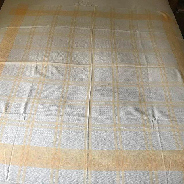 Preview of the first image of Vintage white & yellow patterned tablecloth. Approx 48" sq..