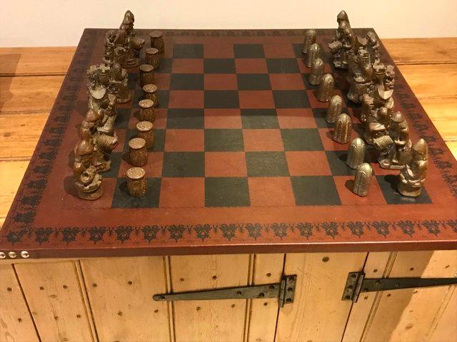 Preview of the first image of Antique Lewis style chess set with filled metal pieces.
