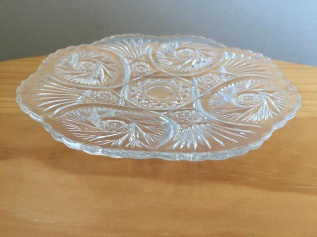 Preview of the first image of Pretty shallow patterned clear glass dish with scalloped rim.