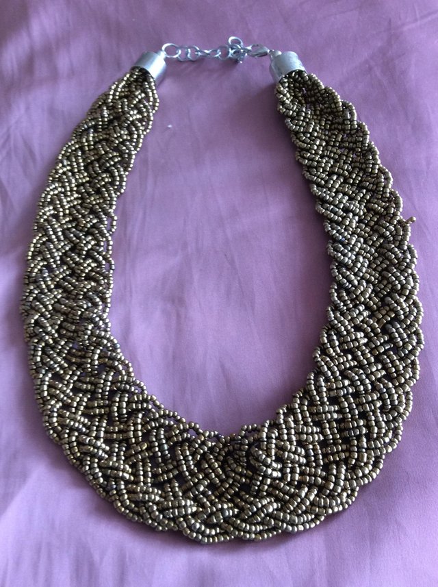 Preview of the first image of Gold/Rust coloured woven necklace.