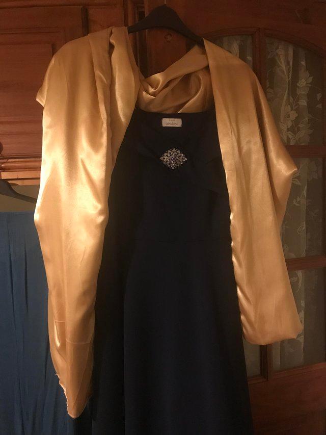 Preview of the first image of Navy fishtail dress size 24 and gold shawl.