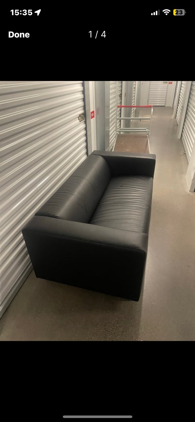 Preview of the first image of Black Leather Sofa, Under 2 Months Old.