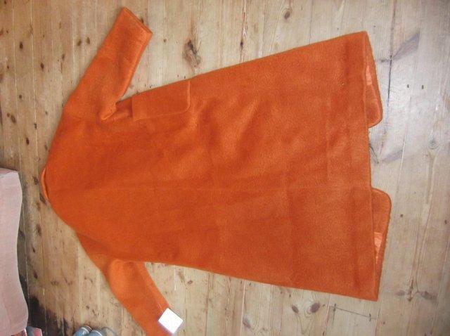 Preview of the first image of Womans Topshop brushed long coat in burnt orange.