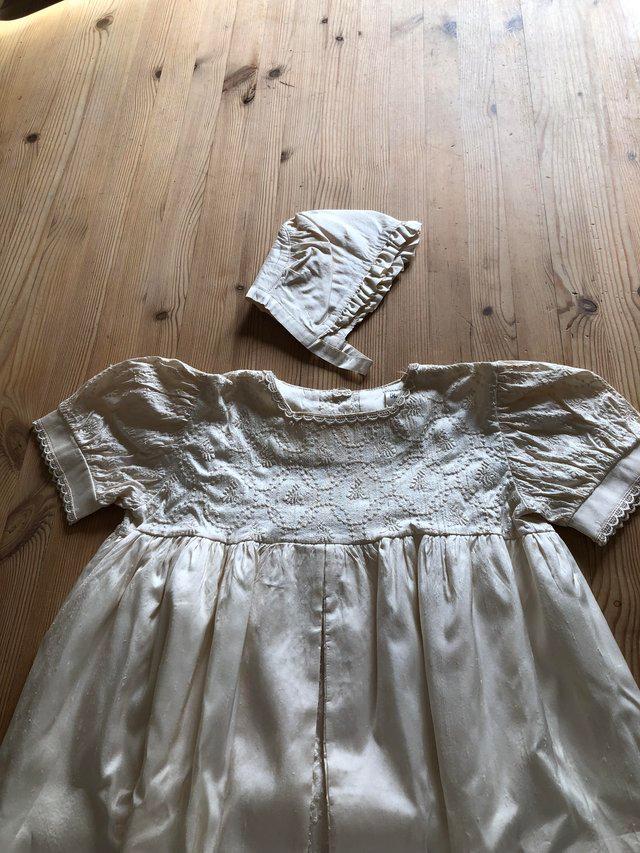 Preview of the first image of Child’s christening gown and bonnet..