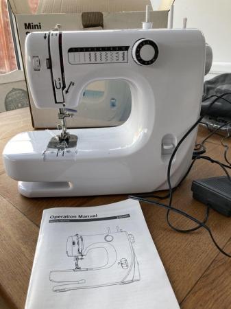 Image 1 of Mini sewing machine. Good Condition with box and operators m