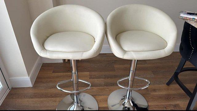 Preview of the first image of Two cream kitchen bar stools - hardly used.