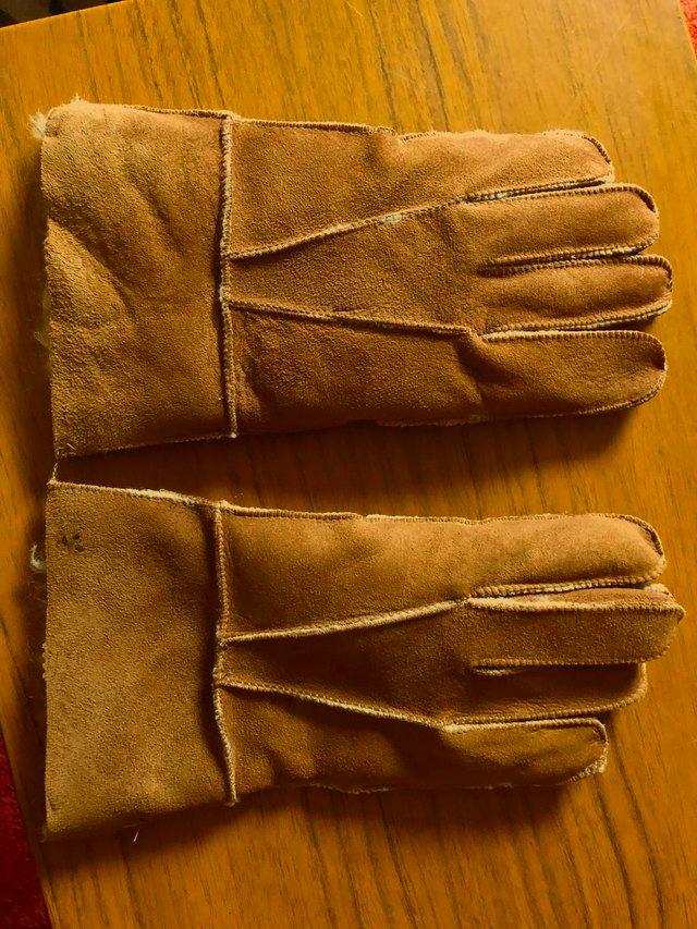 Preview of the first image of NEW SHEEPSKIN GLOVES IN SIZE LARGE.