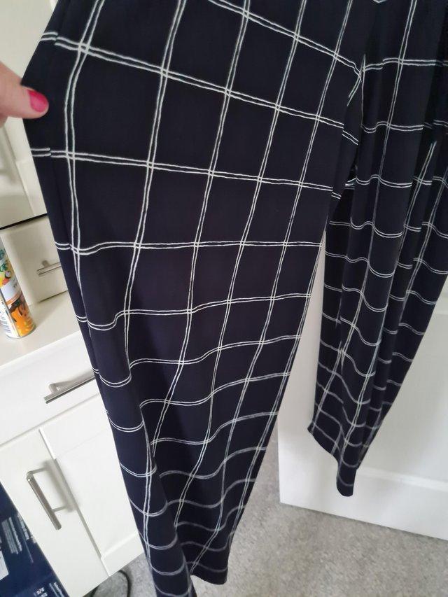 Preview of the first image of Phase Eight wide legged navy and white checked jumpsuit.