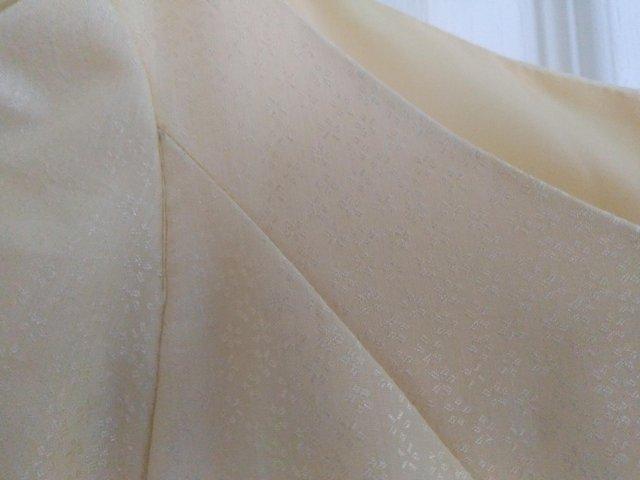 Preview of the first image of Long lemon coloured dress with short sleeves.