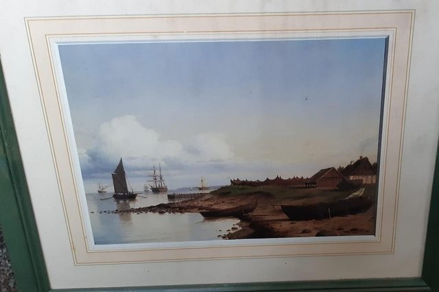 Preview of the first image of Small watercolour painting boat shoreline print in frame.