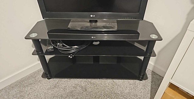 Preview of the first image of Black glass 2 tier tv stand FREE.