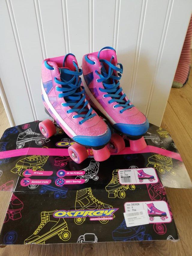 Preview of the first image of Roller skates, adult size 4, chevron pink design.