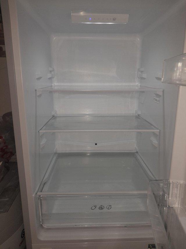 Preview of the first image of Candy fridge freezer 12 months old.
