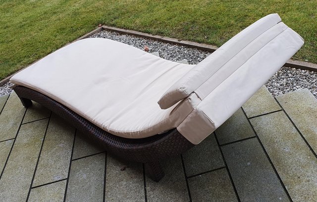 Preview of the first image of Rattan sun lounger with padded upholstery.