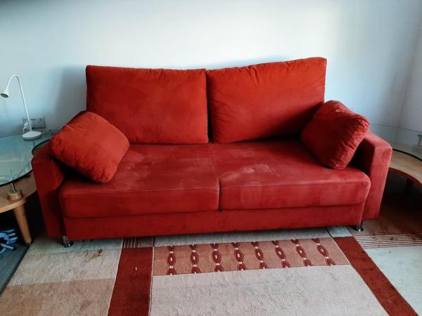 Image 1 of Red sofa with metal feet and pullout bed with storage
