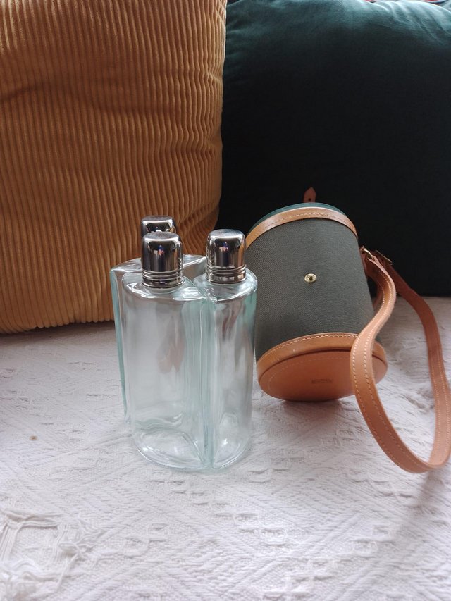Preview of the first image of Vintage glass drinking bottles in Leather case.