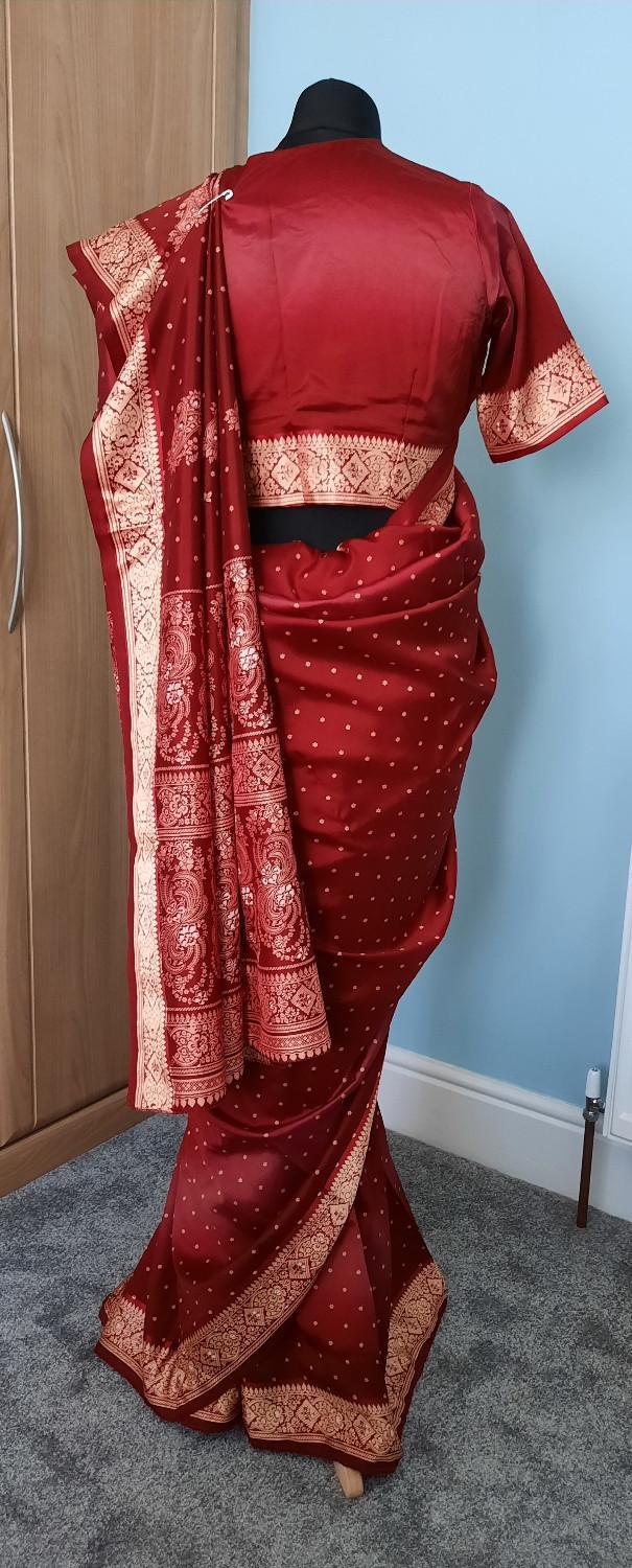 Preview of the first image of Rich burgandy and gold embrodiery design silk saree.