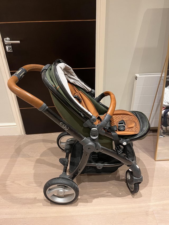 Preview of the first image of “Gently Used Chic Green and Tan Egg Pram: Stylish, Comfortab.