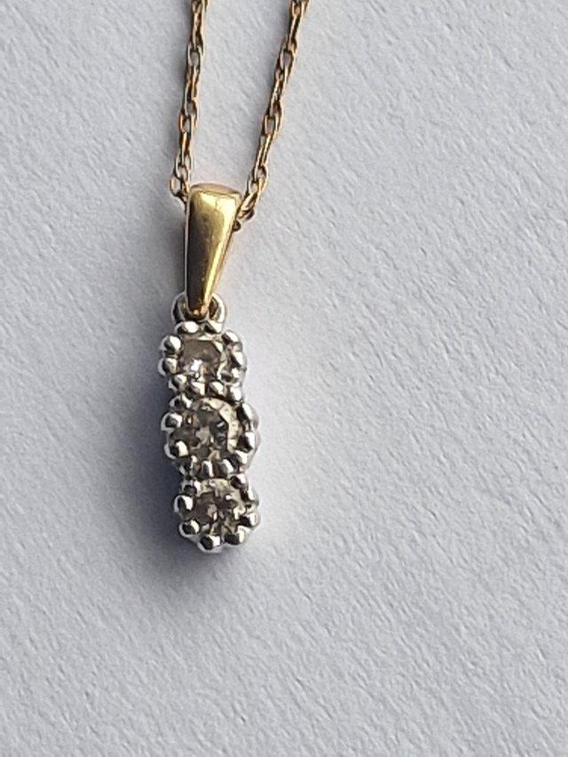 Preview of the first image of A 1/4crt diamondgold necklace.