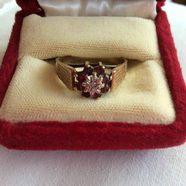 Preview of the first image of Vintage garnet and diamond gold cluster ring.