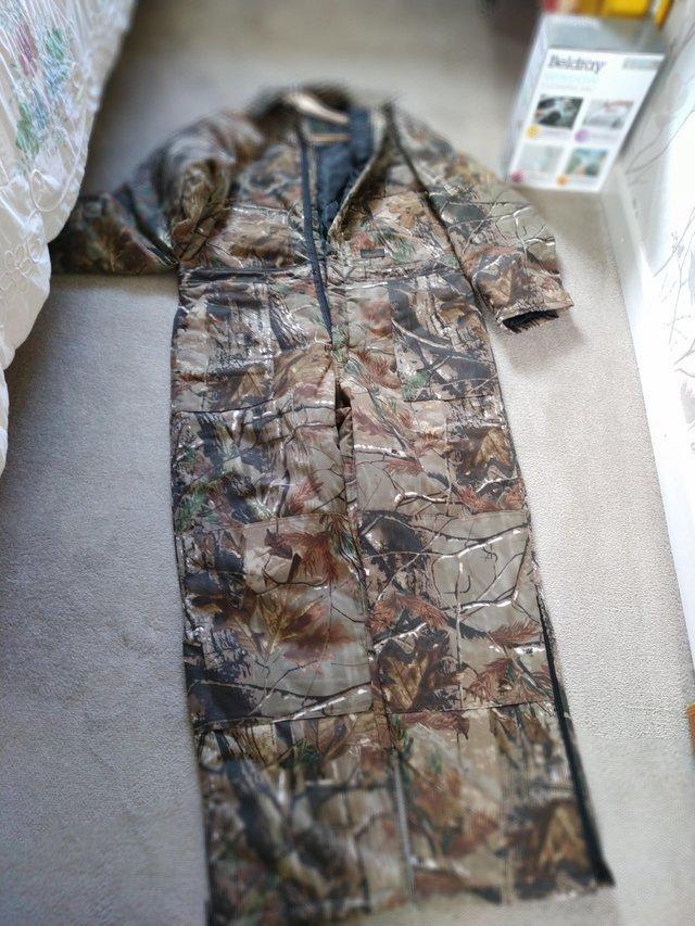Preview of the first image of Realtree Liberty all in one camo suit.