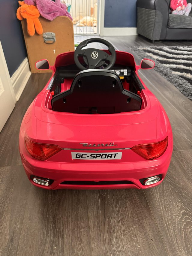 Preview of the first image of Pink Maserati dual control kids sit in car.