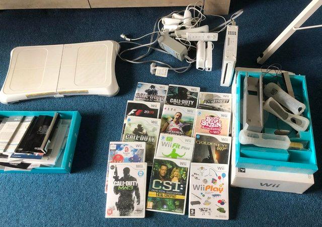 Preview of the first image of Nintendo Wii plus games and Wii fit board.