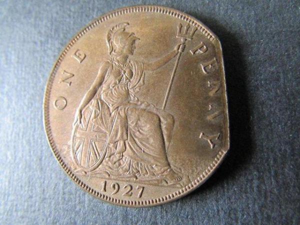 Image 1 of 1927 GEORGE V ONE PENNY WITH PART OF SIDE MISSING.