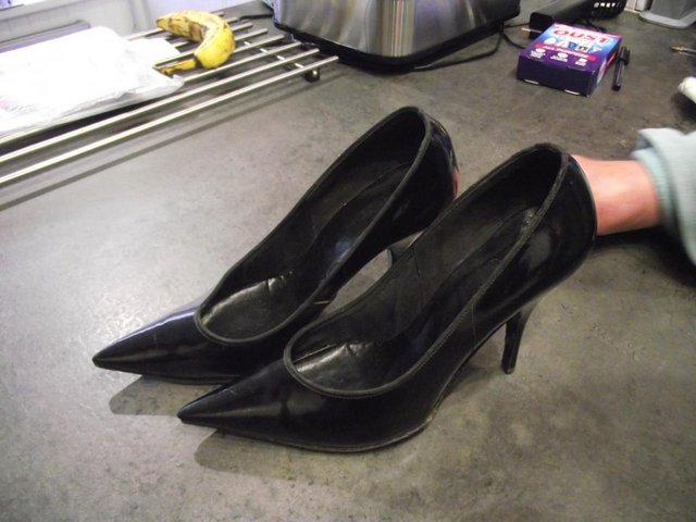 Preview of the first image of A pare of black patent leather high heels.