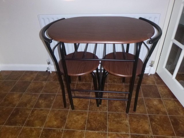 Preview of the first image of COMPACT BISTRO/DINING 3 PIECE TABLE AND CHAIRS.