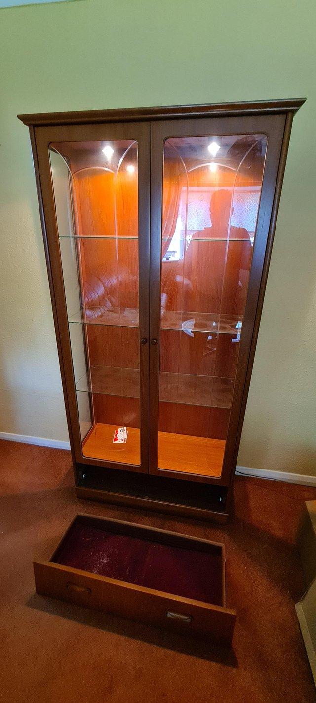 Preview of the first image of Beautiful tall wood and glass display cabinet with light.