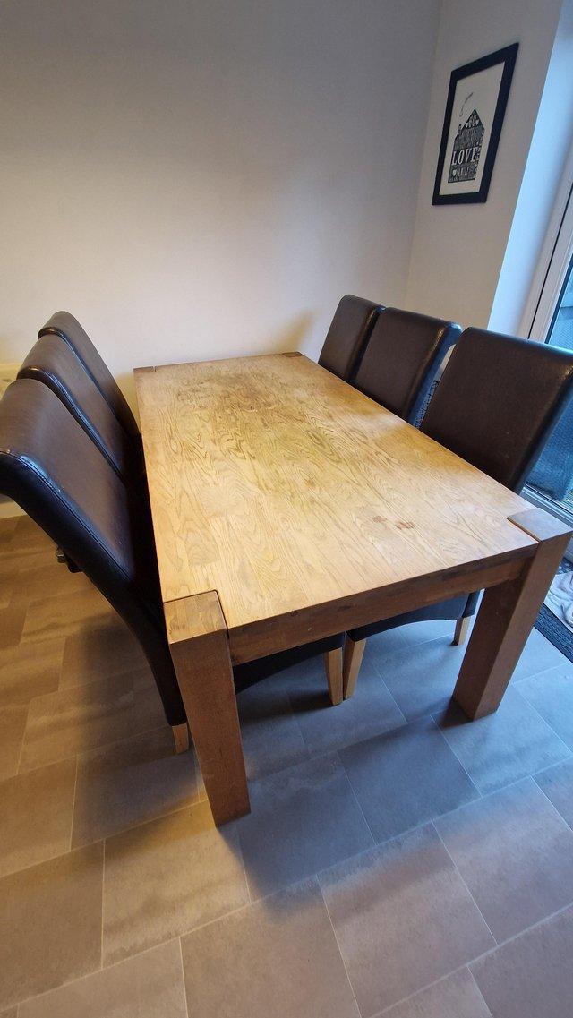 Preview of the first image of Homebase Solid Oak Table and 6 Chairs.
