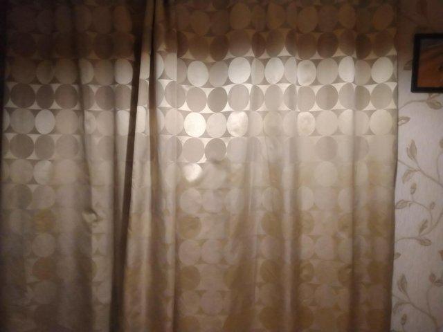Preview of the first image of Light gold lined curtains great condition.