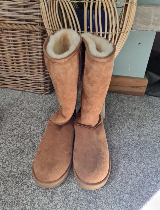Preview of the first image of Tall UGG boots never worn sheepskin.