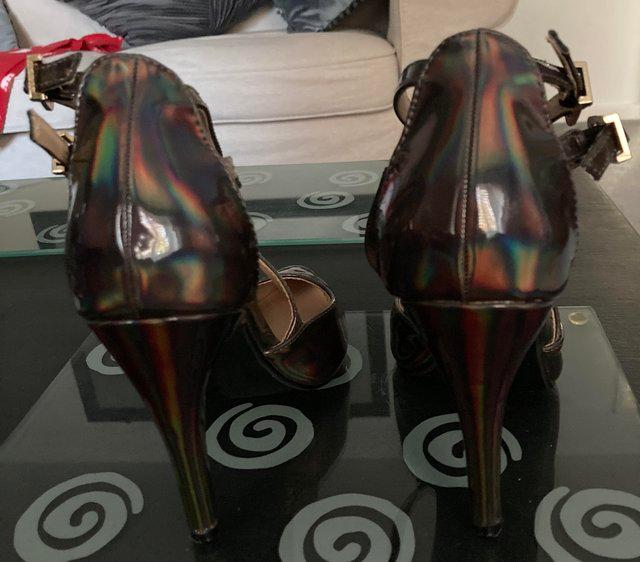Preview of the first image of Beautiful size 4 metallic high heel shoes.